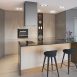 Kitchen with an island, bar stools and a built-in wine rack